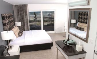 a modern bedroom with a large bed and a flat screen tv mounted on the wall at Lotus Boutique Inn and Suites