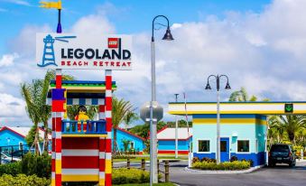"a colorful lego - themed resort building with a sign that reads "" legoland beach retreat .""." at Legoland Beach Retreat