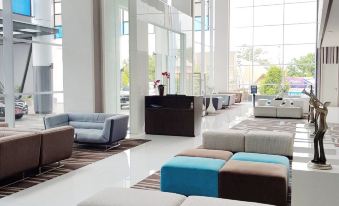 a modern , spacious lobby with multiple couches and chairs arranged in an open space , creating a comfortable and inviting atmosphere at Bromo Park Hotel Probolinggo