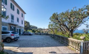a large bed with a wooden headboard and white linens is situated in a room with two lamps at Villa Eugenia