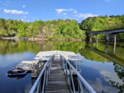 Luxurious cabin with fire pit, kayaks, and dock.