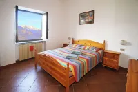 Large apartment with covered outdoor patio with table and barbecue.