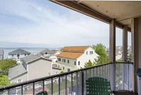 Contemporary, clean 1-bedroom mid-town condo with bay view and 1 block to beach.