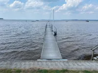 Rustic home on wooded lot, very private. Lake and dock access. Close to trails.