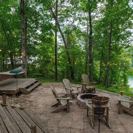 Luxurious cabin with fire pit, kayaks, and dock.