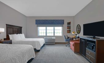 a hotel room with two beds , a desk , and a tv , all neatly arranged in a cozy atmosphere at Hampton Inn Bath (Brunswick Area)