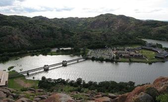 a large body of water surrounded by a mountainous landscape , with a bridge spanning the waterway at Quartz Mountain Resort