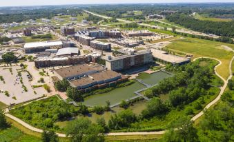 an aerial view of a large city with buildings , roads , and water bodies , surrounded by greenery at Hyatt Regency Coralville Hotel & Conference Center
