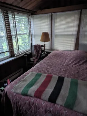 Direct lakefront cottage with wood burning fireplace in great room. Pet friendly