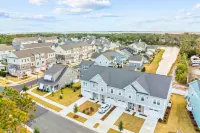 Coastal townhome with outdoor living, central AC, washer/dryer, & pool access