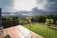 Villa in the mountains in front of a lake.
