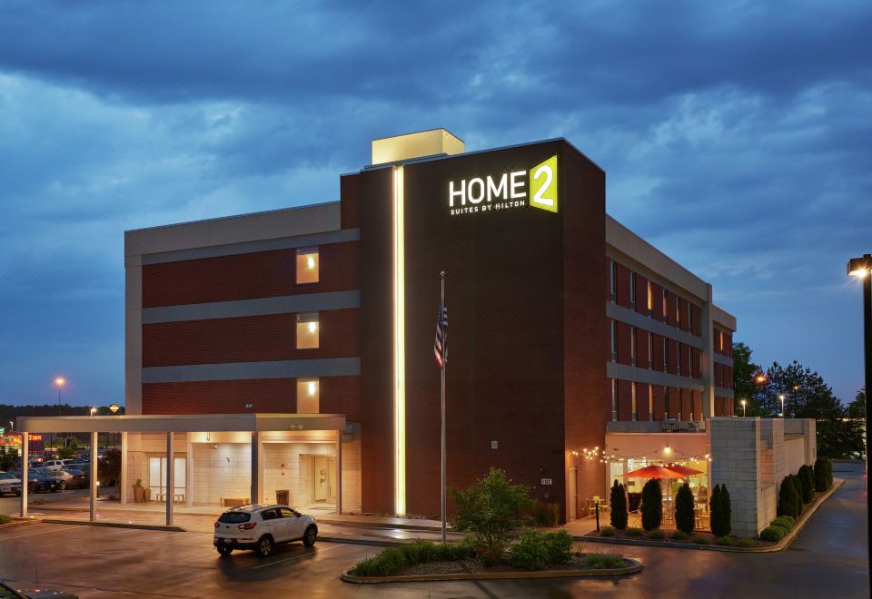 "a large hotel with a sign that says "" home 2 "" and a flag in front of it" at Home2 Suites by Hilton Youngstown West/Austintown