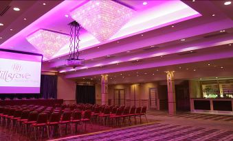 a large conference room with rows of chairs arranged in a semicircle , ready for an event at Hillgrove Hotel, Leisure & Spa
