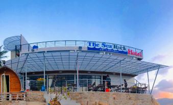 "a large , modern building with a sign that reads "" the sea turtle hotel "" prominently displayed on the front" at The Sea Rock Binh Hung