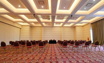 a large conference room with rows of chairs arranged in a semicircle , ready for a meeting at DiplomaticHotel