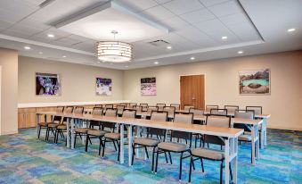 a conference room with rows of chairs arranged in a semicircle , ready for a meeting or presentation at Home2 Suites by Hilton Fort Mill