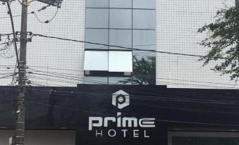 "the exterior of a modern building with the name "" prime hotel "" on it , along with several street lights and power lines" at Prime Hotel