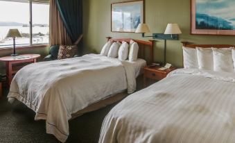 a hotel room with two beds , one on the left and one on the right side of the room at Westmark Sitka