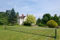 Manor house set in five acres of gardens with private golf course, near Ludlow.