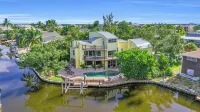 spectacular architectural home steps to the beach w/private heated pool on canal