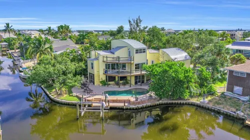 spectacular architectural home steps to the beach w/private heated pool on canal