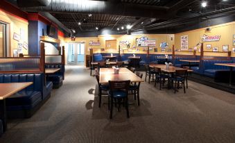 a restaurant with several dining tables and chairs , some of which are occupied by people at Holiday Inn Rock Springs