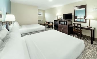 a hotel room with two beds , a desk , and a television , all neatly arranged in the room at Top Notch Inn