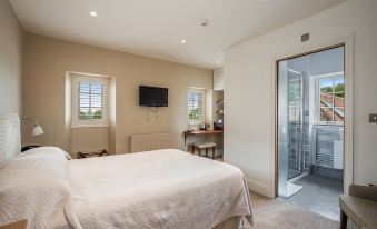 a bedroom with a large bed , television , and sliding glass doors leading to an outdoor area at Castle of Comfort Hotel