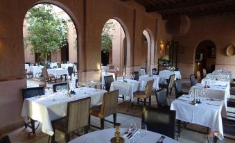 an elegant dining room with numerous tables and chairs set up for a formal event at Kasbah Bab Ourika