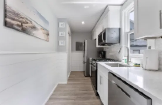 Stainless Steel Appliances and Flat-Screen TV - Modern Coastal Retreat