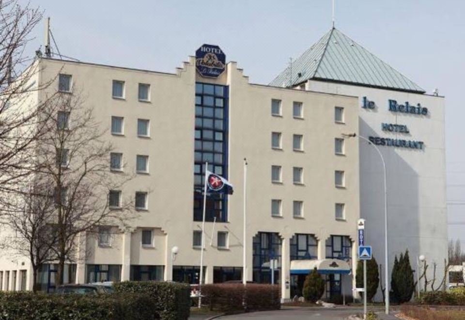 "a large , white building with a sign that reads "" hotel bremen "" on the side of the building" at Ibis Styles Lille Marcq-en-Baroeul