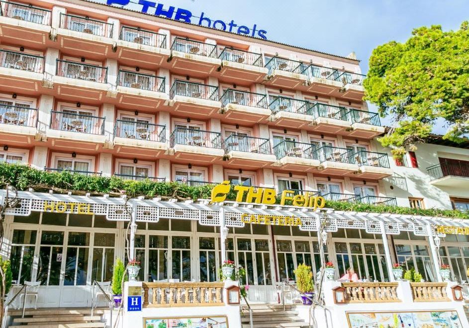 "a large hotel building with a sign that reads "" the real "" on the front of the building" at THB Felip - Adults Only