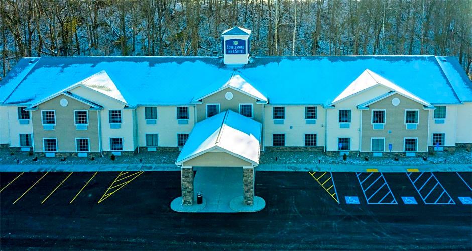 an aerial view of a blue and white motel with snow on the ground , trees in the background at Cobblestone Inn & Suites - Brookville