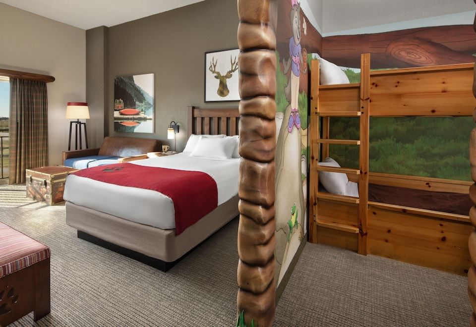 a hotel room with a bunk bed and a single bed , both adorned with animal - themed bedding at Great Wolf Lodge Grapevine