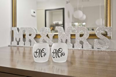 "a couple of wedding decorations , including a large sign that says "" mr & mrs "" and two matching glasses with the word "" mr & mrs" at Country Inn & Suites by Radisson, Watertown, SD