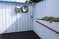 PORTHOLE:  Peaceful with a private, locked, covered patio to relax/ store bikes.