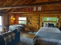 Cozy waterfront log cottage with huge outdoor living area.