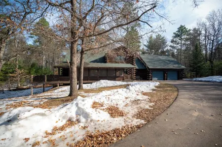 Exceptional log home on 9+ acres with frontage on Big St. Germain Lake