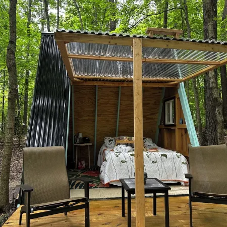 Charming A-frame cabin set in the woods overlooking deep wooded ravines.