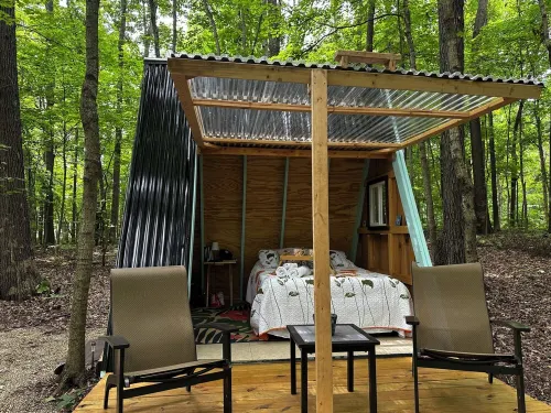 Charming A-frame cabin set in the woods overlooking deep wooded ravines.