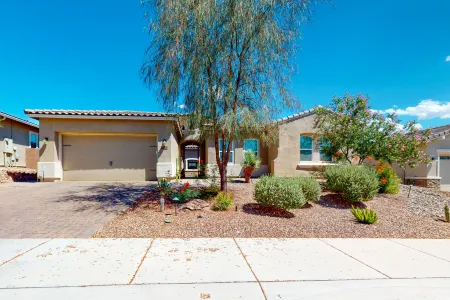 Southwestern stunner with enclosed yard, pool, putting green, & grill