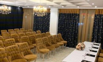 a conference room set up for a meeting , with chairs arranged in rows and a table in the center at Hotel Empire Albania