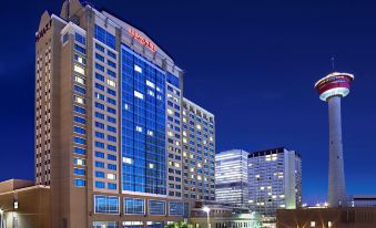 "a tall hotel building with a sign that reads "" mandalay bay hotel "" is surrounded by other buildings" at Hyatt Regency Calgary