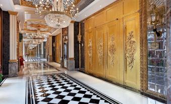 A large room with gold walls and floors is located next to the lobby, featuring ornate decorations at Hotel Alexandra