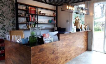 a modern kitchen with a wooden bar counter and shelves filled with various items , creating a cozy atmosphere at Pool House Lanska