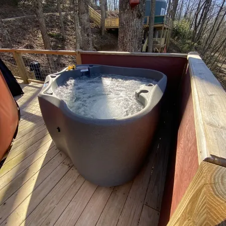 Elevated eclectic yurt with wrap-around porch, hot tub, and mountain view!