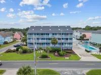 Beach Getaway - First floor unit with Pool and beach access steps away!