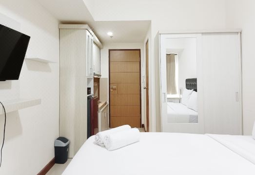 호미 드 타이디 스튜디오 아파트먼트의 편안한 침대 이미지