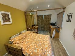 Peaceful separate annexe with bed, kitchen, shower room and patio area.