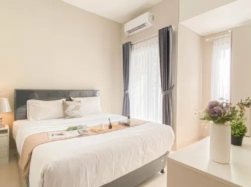 Soft Grey 1BR at Royal Sentul Park Apartment By Travelio